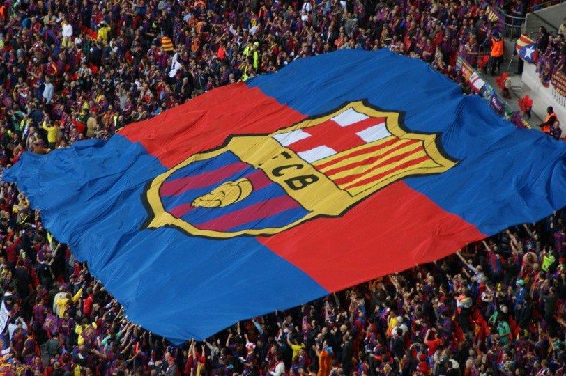 large barça flag covering a section of the stadium